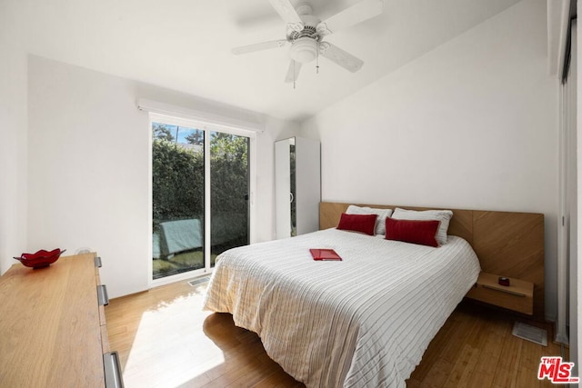 bedroom with access to exterior, light hardwood / wood-style flooring, and ceiling fan