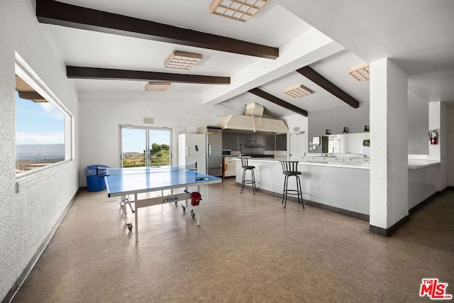 rec room with lofted ceiling with beams