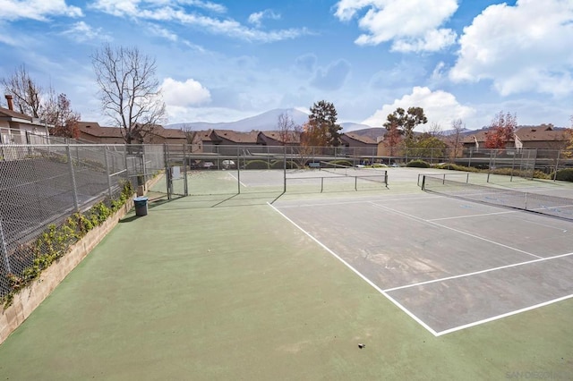 view of tennis court with a mountain view