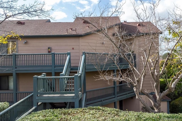 back of house featuring a balcony