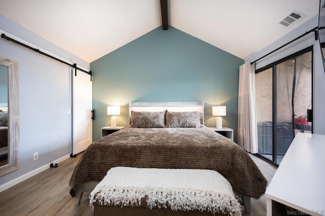 bedroom with vaulted ceiling with beams, wood-type flooring, a barn door, and access to outside