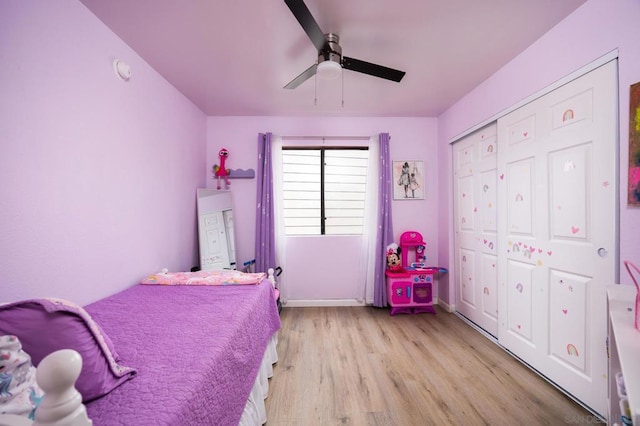 bedroom featuring ceiling fan, a closet, and light wood-type flooring