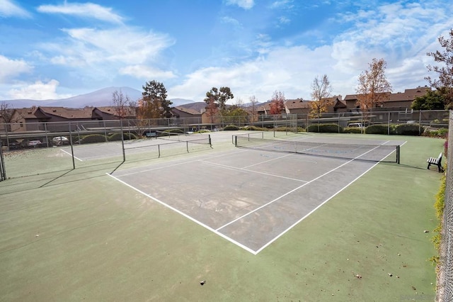 view of tennis court with a mountain view