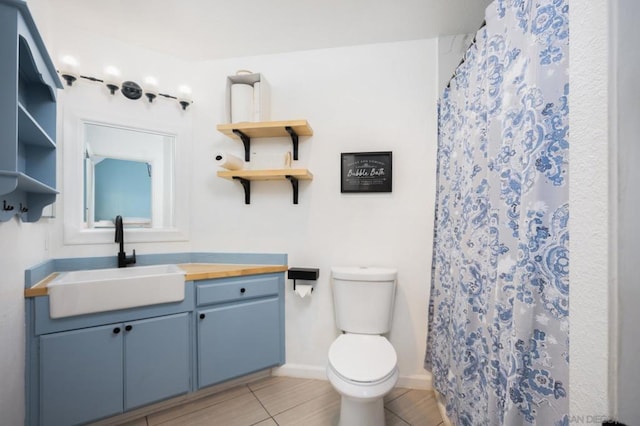 bathroom with vanity, tile patterned floors, toilet, and a shower with shower curtain