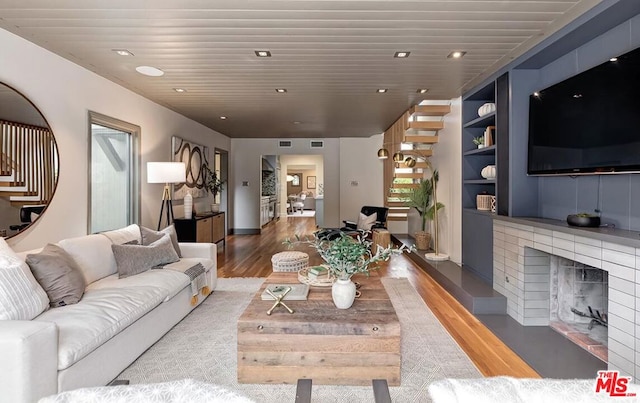 living room featuring dark hardwood / wood-style flooring and built in features