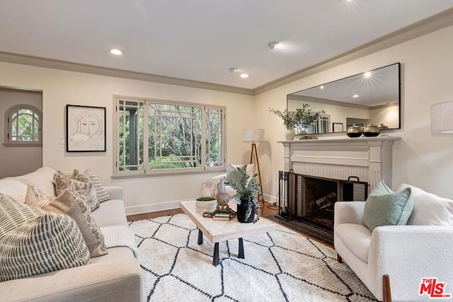 living room with a brick fireplace, crown molding, and light wood-type flooring