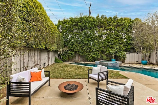 view of patio / terrace with a pool with hot tub and an outdoor living space with a fire pit