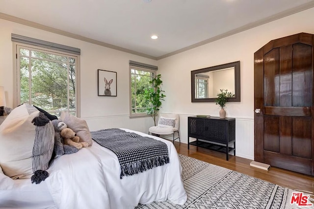 bedroom with hardwood / wood-style flooring and crown molding