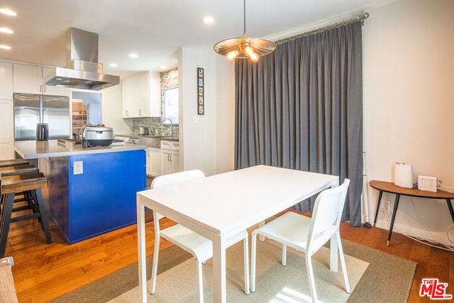 dining room with dark hardwood / wood-style flooring and sink