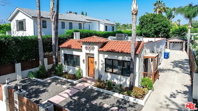 view of front facade featuring a garage and central AC unit