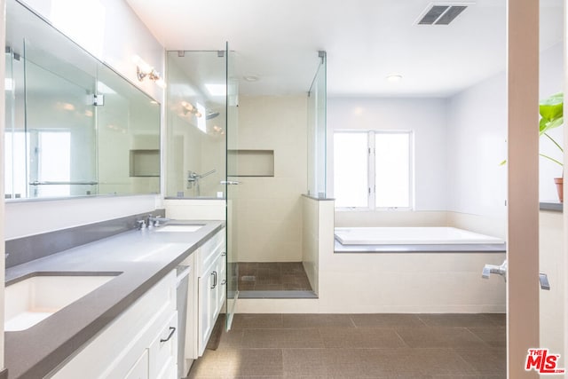 bathroom featuring shower with separate bathtub and vanity