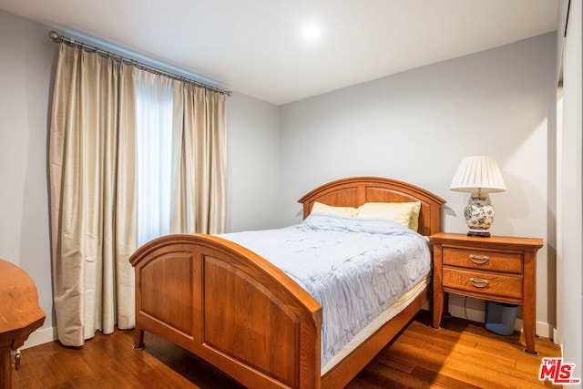 bedroom with wood-type flooring