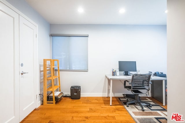 office space with light hardwood / wood-style flooring