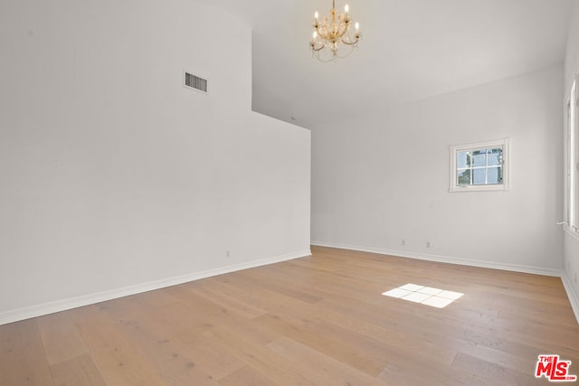 interior space featuring an inviting chandelier, high vaulted ceiling, and light hardwood / wood-style floors