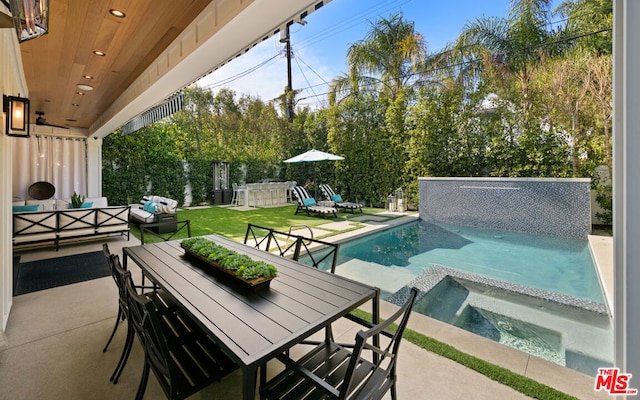 view of patio featuring outdoor lounge area and a pool with hot tub