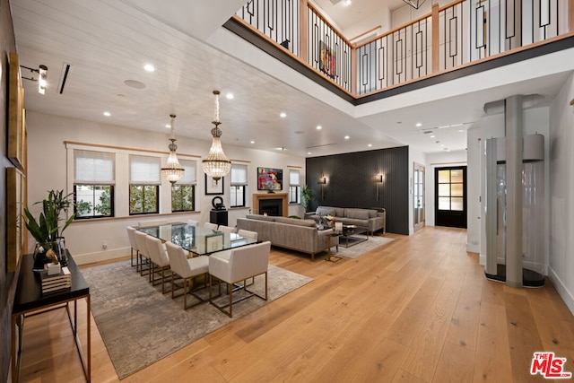 living room featuring a high ceiling and light hardwood / wood-style flooring