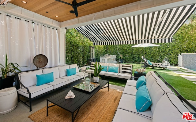 view of patio / terrace with ceiling fan and an outdoor living space