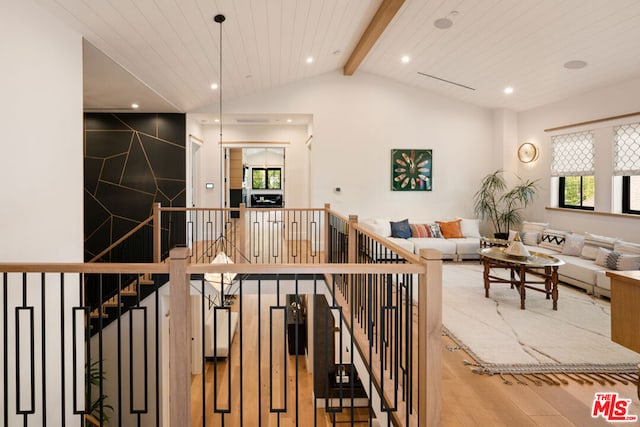 staircase with vaulted ceiling with beams, wood-type flooring, and wooden ceiling