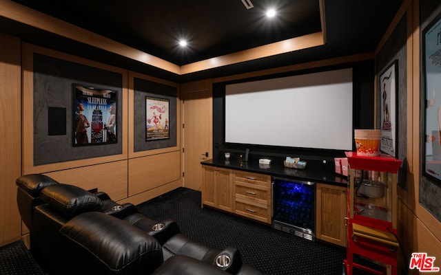 home theater room with carpet, beverage cooler, and a tray ceiling