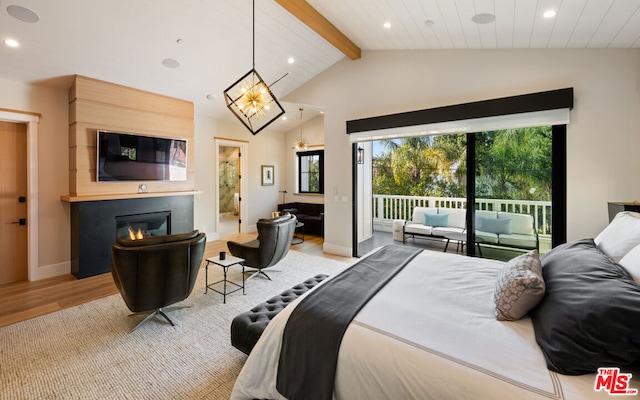 bedroom featuring a fireplace, access to exterior, multiple windows, and vaulted ceiling with beams