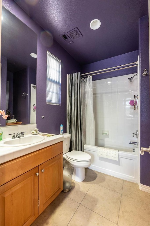 full bathroom with shower / bathtub combination with curtain, tile patterned flooring, vanity, a textured ceiling, and toilet