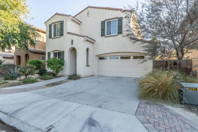 mediterranean / spanish-style house with a garage