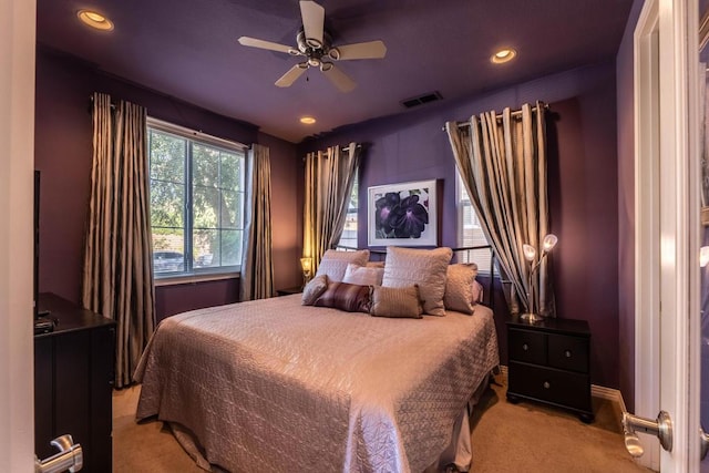 bedroom with light carpet and ceiling fan