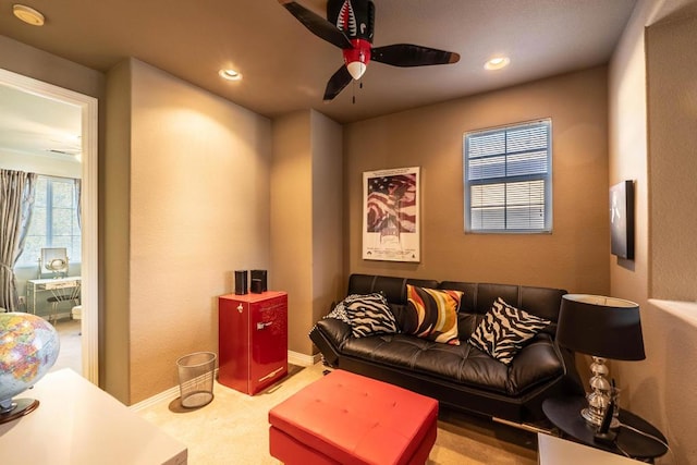 carpeted living room featuring ceiling fan