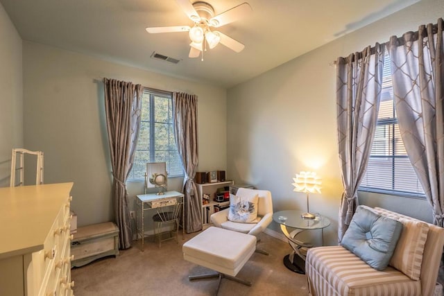 living area featuring ceiling fan and carpet floors