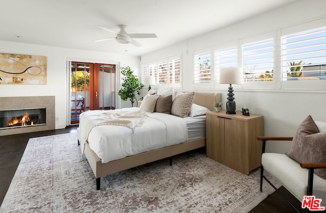 bedroom featuring access to exterior, hardwood / wood-style floors, french doors, and ceiling fan