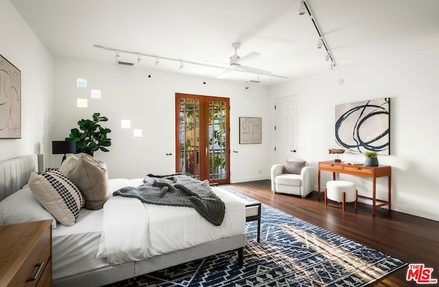 bedroom with rail lighting, dark hardwood / wood-style flooring, access to outside, ceiling fan, and french doors