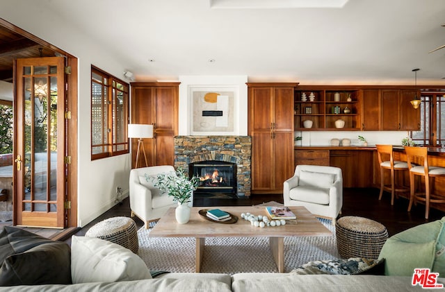 living room featuring dark hardwood / wood-style flooring and a fireplace