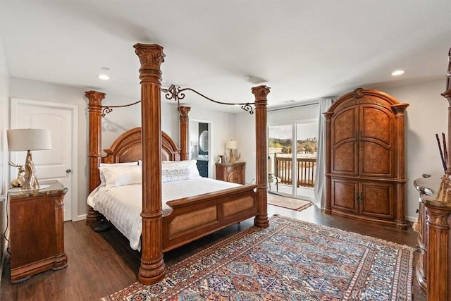 bedroom with decorative columns, access to outside, and dark hardwood / wood-style flooring