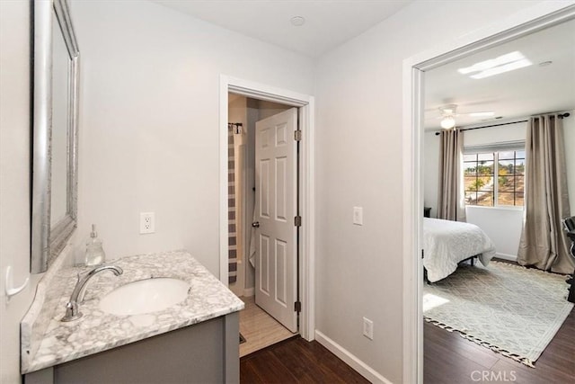 bathroom featuring vanity, wood-type flooring, and ceiling fan