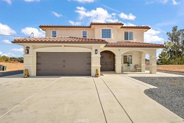 mediterranean / spanish-style house featuring a garage