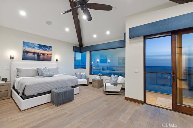 bedroom featuring a water view, ceiling fan, light hardwood / wood-style flooring, and beamed ceiling