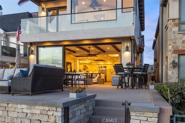 exterior space featuring a balcony, an outdoor hangout area, and a patio area