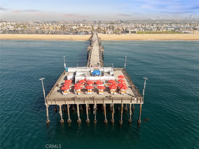 dock area with a water view and a view of the beach