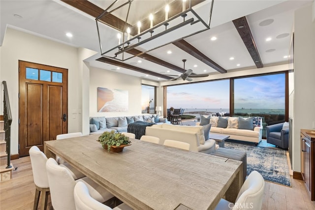 dining space with beamed ceiling and light hardwood / wood-style floors