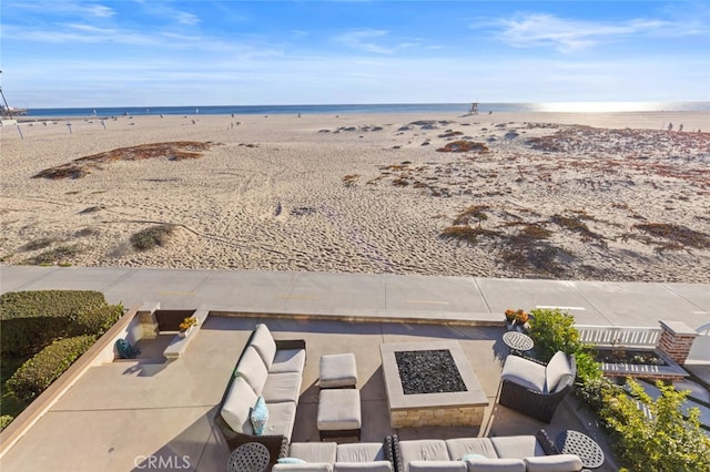 aerial view featuring a water view and a beach view