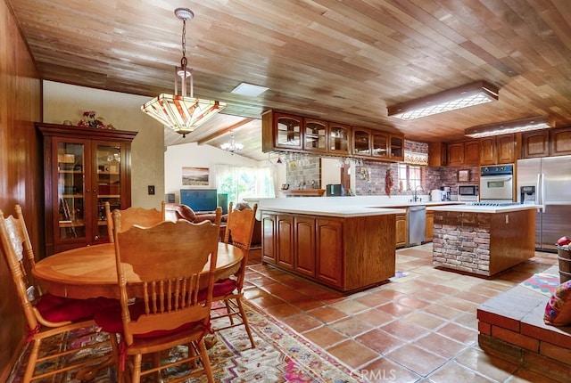 kitchen featuring pendant lighting, wood ceiling, stainless steel appliances, and a kitchen island