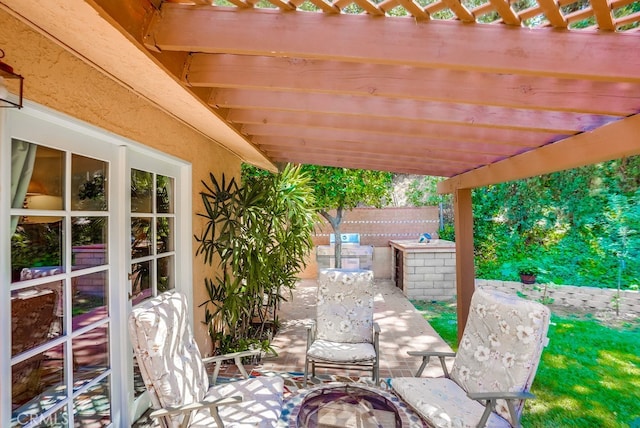 view of patio featuring a pergola and a fire pit