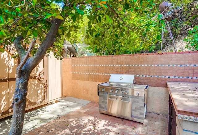 view of patio with area for grilling and exterior kitchen