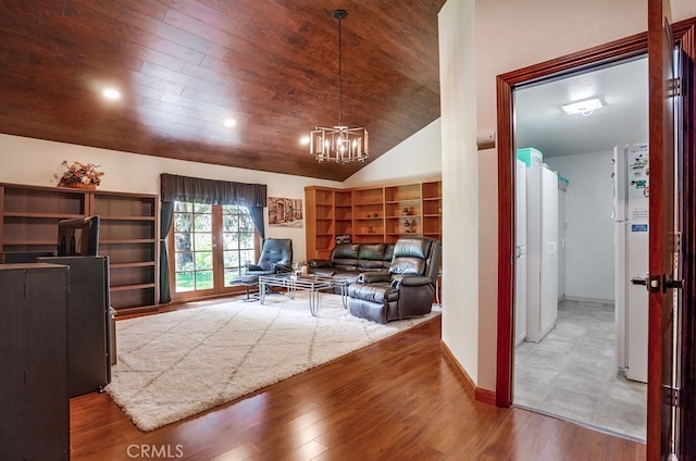 living room with hardwood / wood-style flooring, lofted ceiling, a chandelier, and wood ceiling