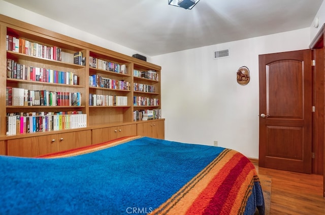 bedroom with hardwood / wood-style flooring