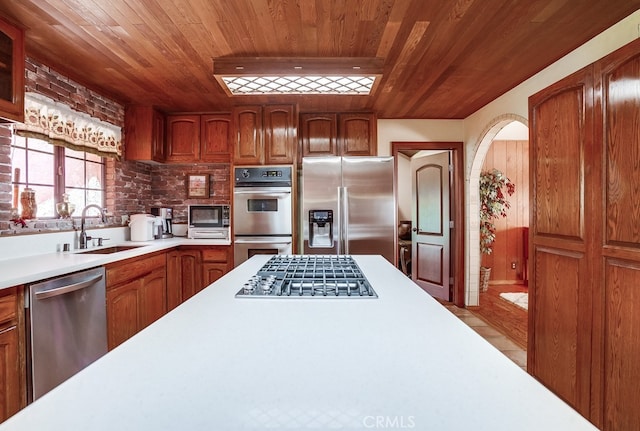 kitchen with stainless steel appliances, sink, and wooden ceiling