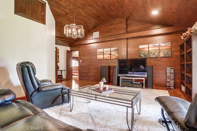 living room featuring an inviting chandelier, hardwood / wood-style floors, high vaulted ceiling, wooden ceiling, and wood walls