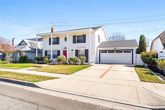 view of front of property featuring a garage and a front lawn