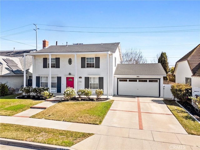 view of front of home featuring a garage and a front lawn