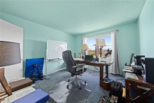 office space with a textured ceiling and dark carpet